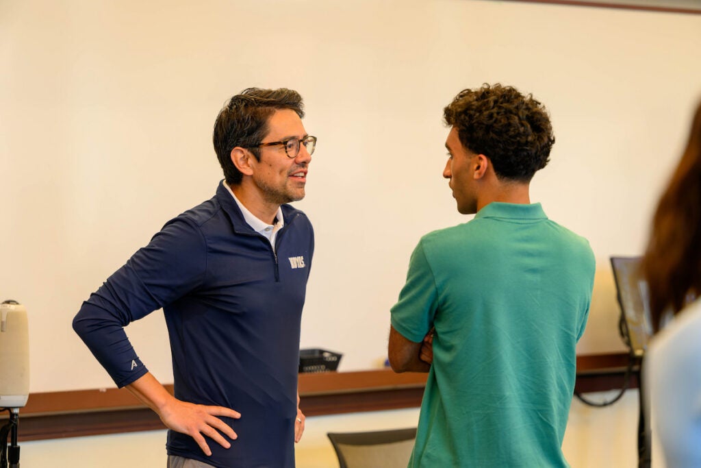 Durban Sports Business Program student speaks with the Executive Director, Luis Maes.
